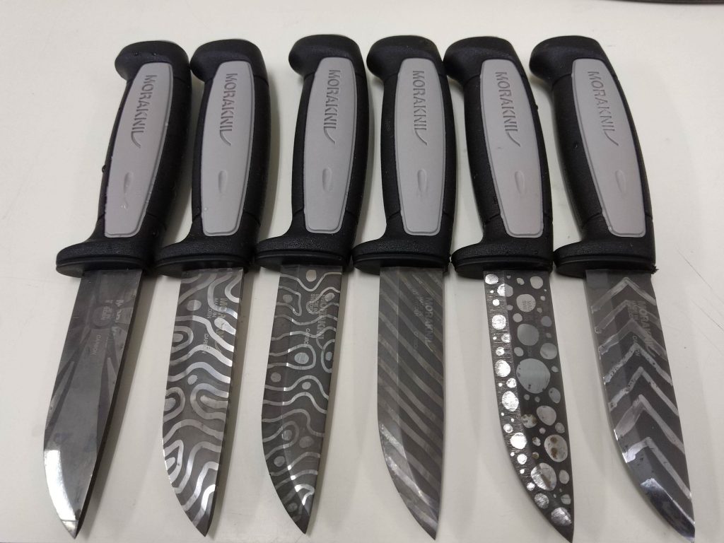 Knives showing the results of ferric chloride etching